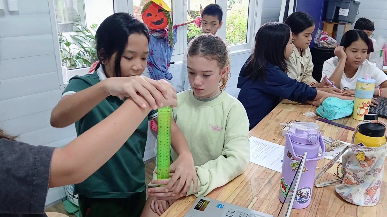 Year 7 students timing their reactions with a falling ruler in a science lab