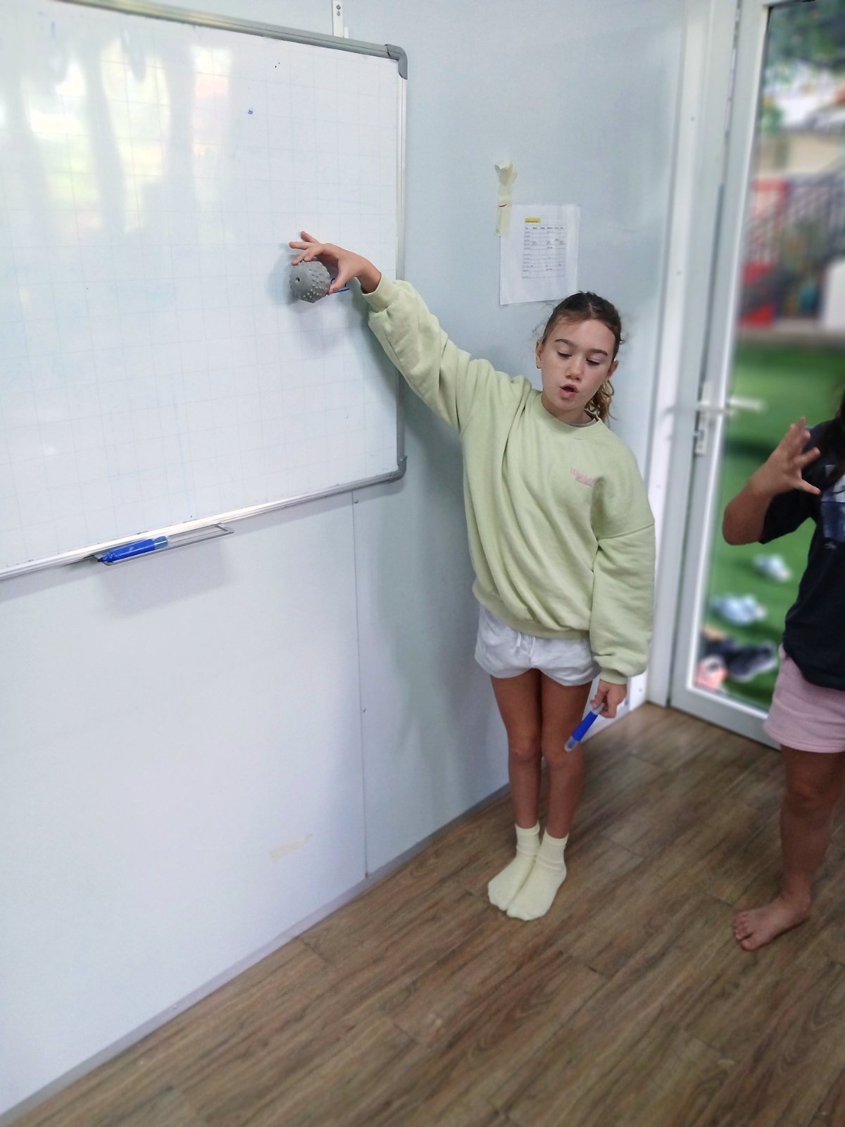 A Year 7 student holding a ball at 150 cm before dropping it