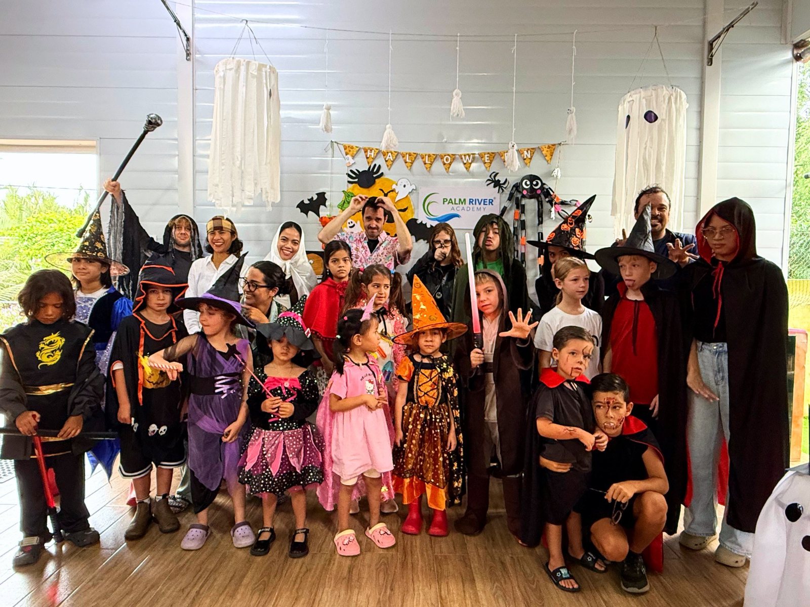 A class and their teachers in Halloween costumes at the Halloween wall
